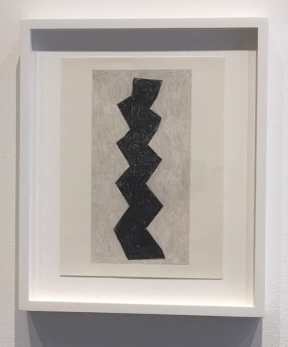 Drawing of a black zig zag on a gray rectangle.