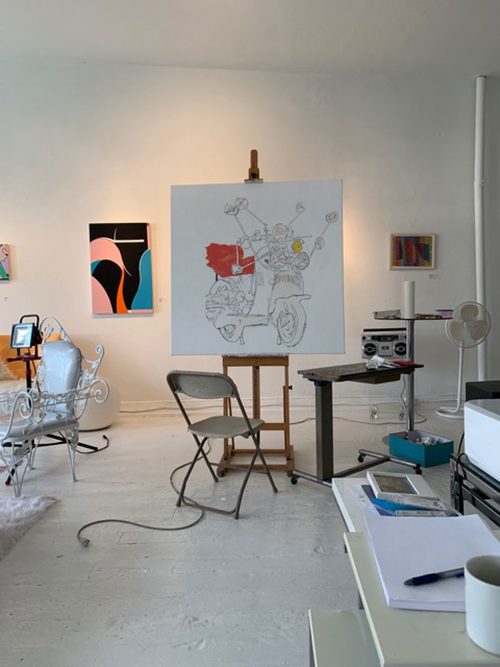 A chair in front of an easel with an in-progress painting.