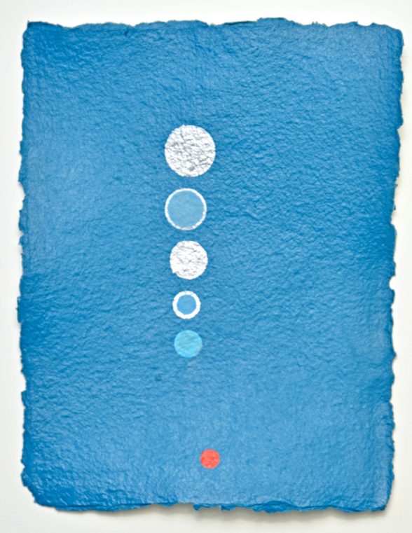 Blue paper with white and red circles going down vertically