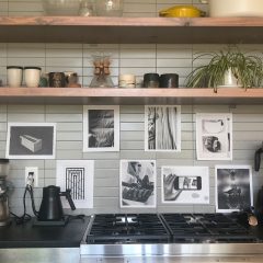 Art hanging in a kitchen above the stove