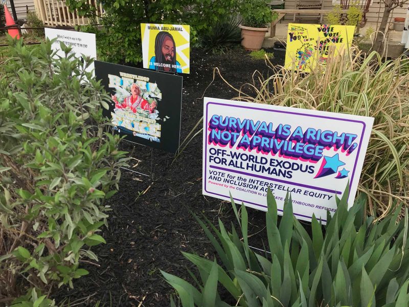 Four of the lawn signs from YIMFY 2020 in Tucker and Bunker's lawn.