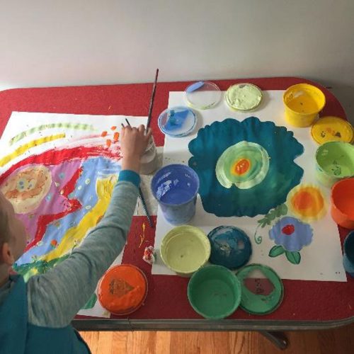 Child painting at a table at home.