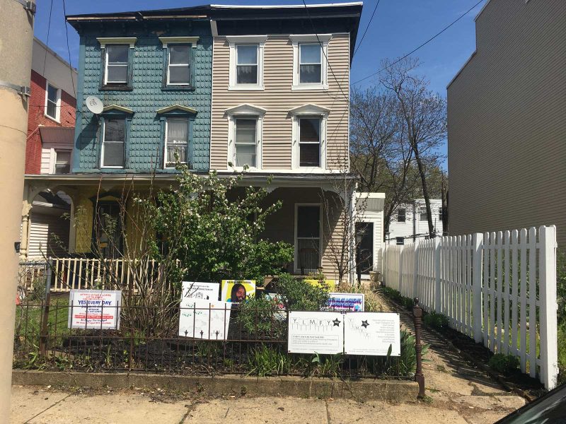 Outside view of Daniel & Emily's house with the YIMFY signs displayed on their lawn.