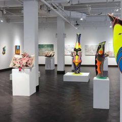 Sculptures, paintings, and pop-up books hanging and displayed in Rowan's art gallery.