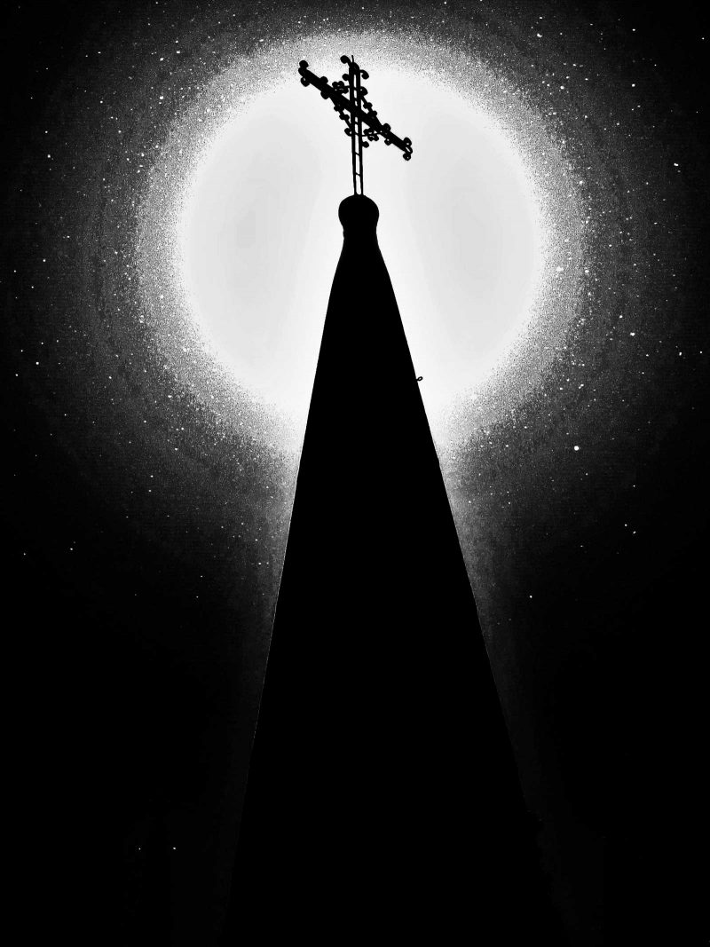 White mass illuminating the top of a steeple in black and white