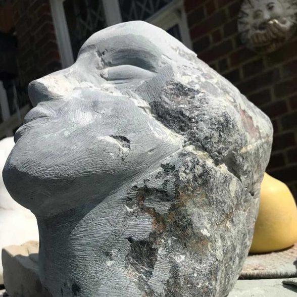Stone statue of a female facial profile.