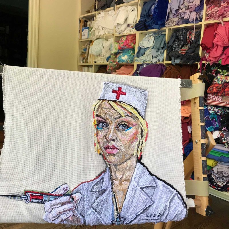 Stiched portrait of a nurse with a needle in her hand in front of a wall of clothing.