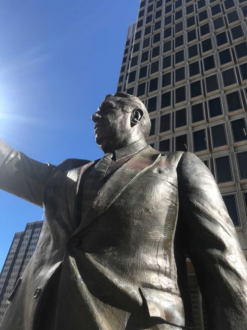 Statue of Rizzo close-up with his arm out.