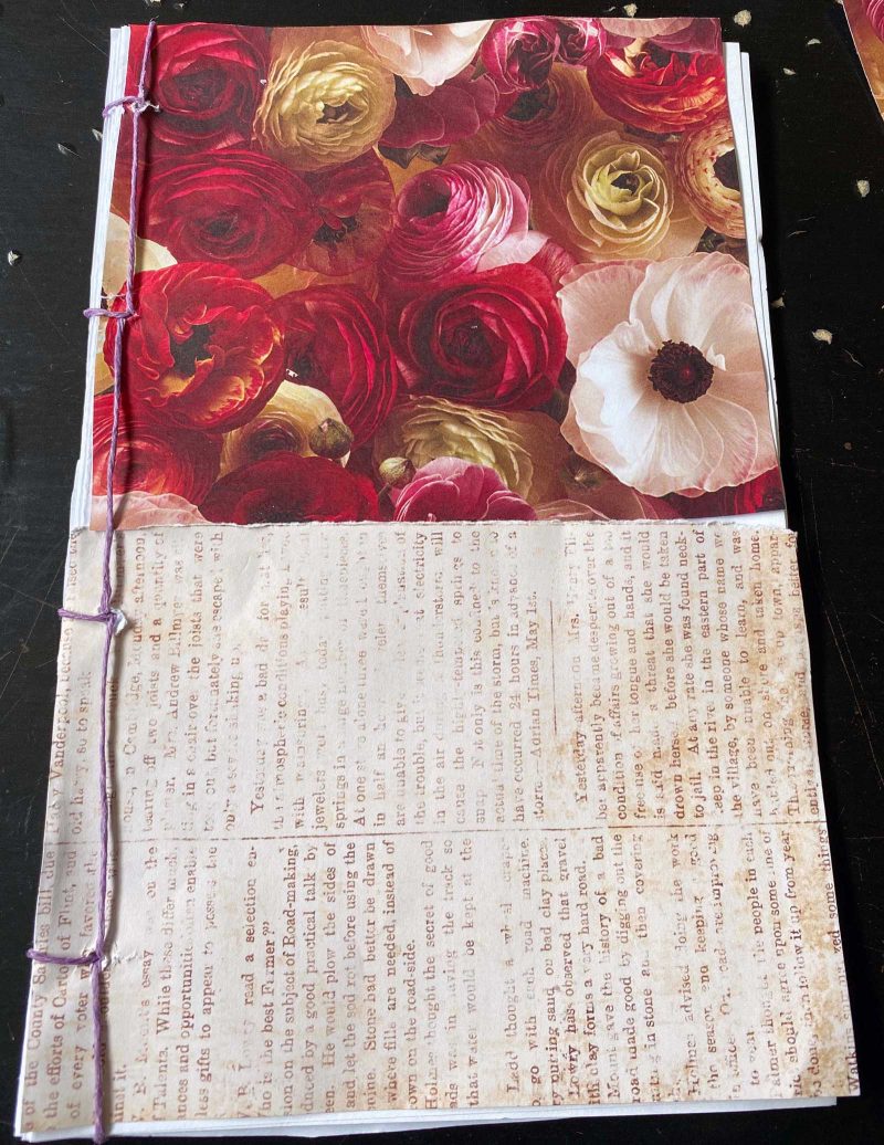 an open book with illegible text on one page and a picture of flowers on the other