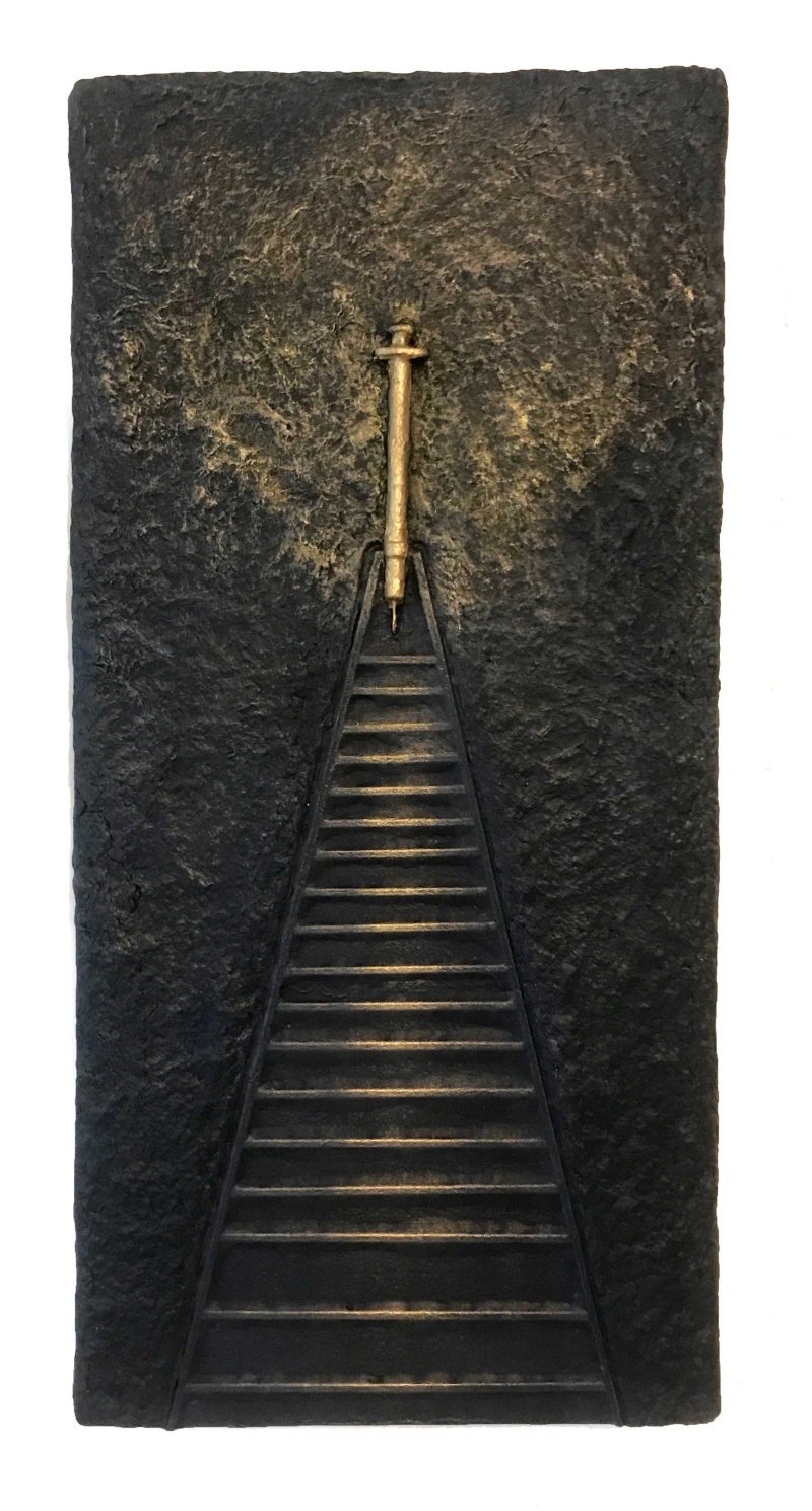 A long paper pulp staircase leading up to a golden syringe that looks like a cross