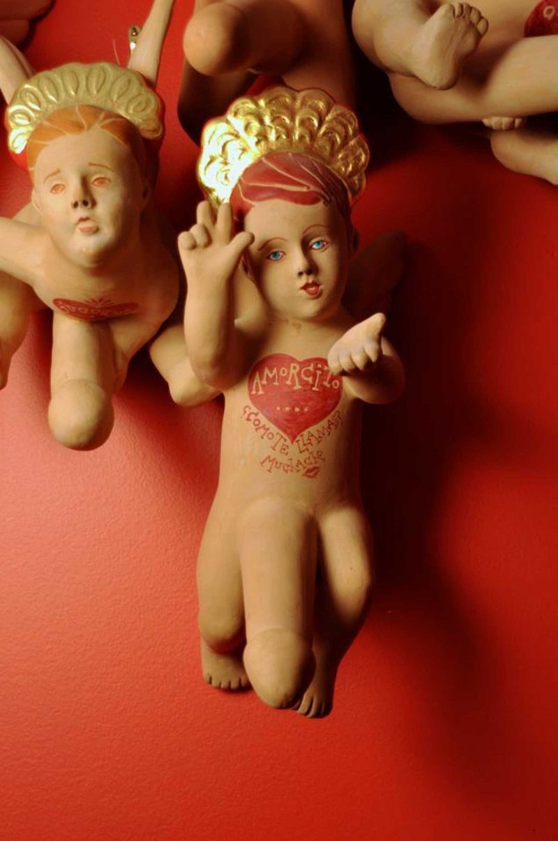 Sculpture of a small cupid with oversized male genitals and a heart on their chest