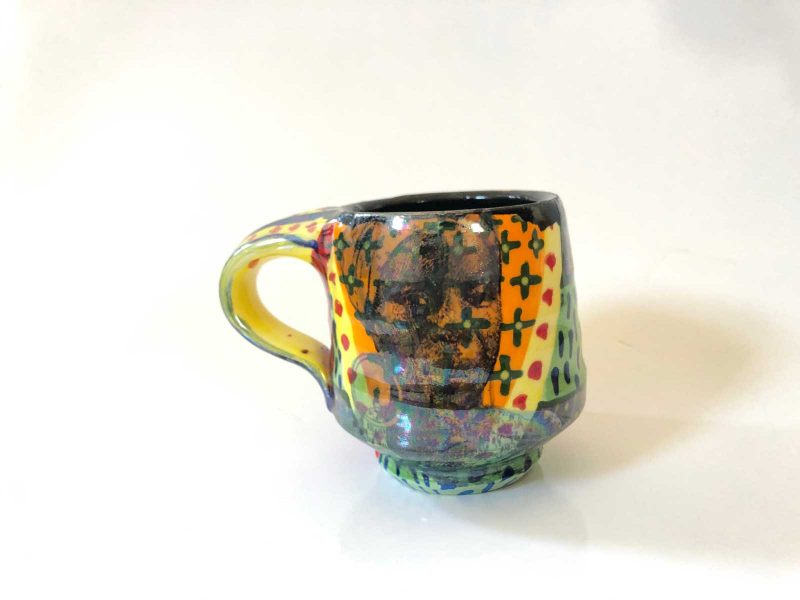 Ceramic cup decorated with patterns and a drawing of Nina Simone