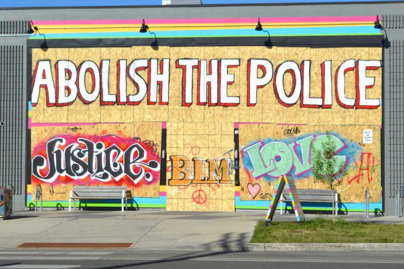 Protest graffiti, "Abolish the Police", "JUSTICE," "BLM", "Love"