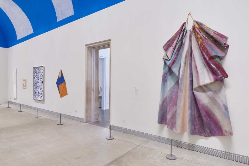 Installation view of the "Expanded Painting" exhibition at the Philadelphia Museum of Art, featuring a large folded painting surface hanging on the wall by Sam Gilliam.