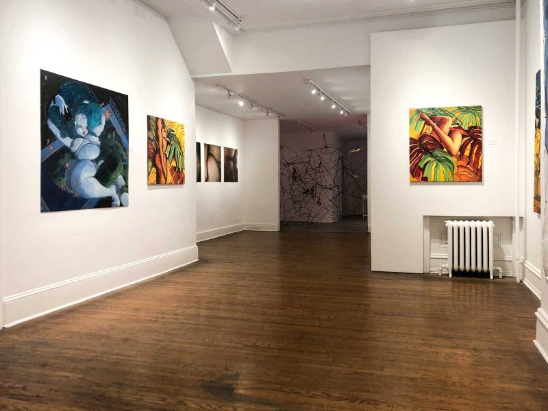 Full gallery view of "Sanctuary: An Exploration of Queer Safe Havens", group exhibition of figurative paintings, close-up photos of body parts, and abstract metal sculpture in the back of the room.