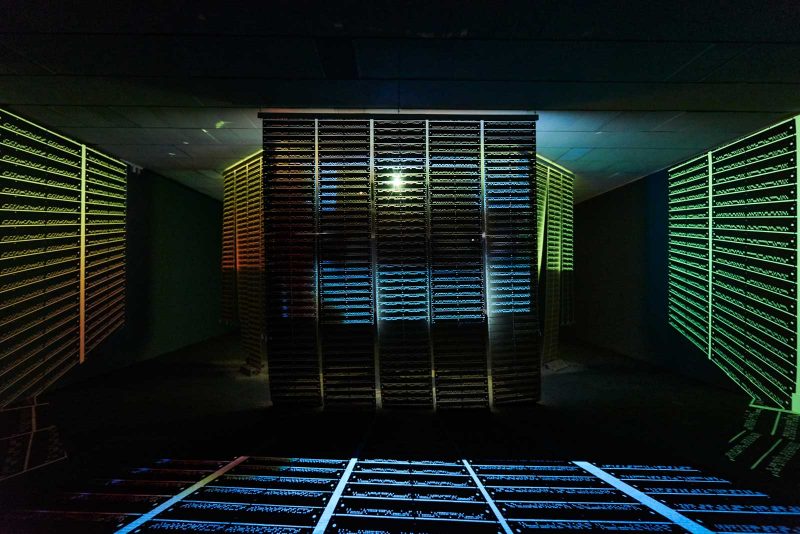Senga Nengudi's "Warp Trance," a video installation displayed on punch cards, allowing some light to pass through and make patterns on the nearby walls and floors.