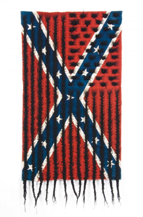 Multimedia hanging sculpture by Sonya Clark of a Confederate flag that has been sewn into with braided black fabric in the pattern of the stars & stripes from the American flag.