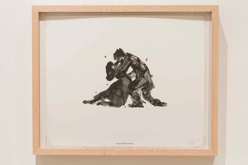 Small, gestural, ink drawing of a man and woman embracing, on white paper, in a light wood frame.