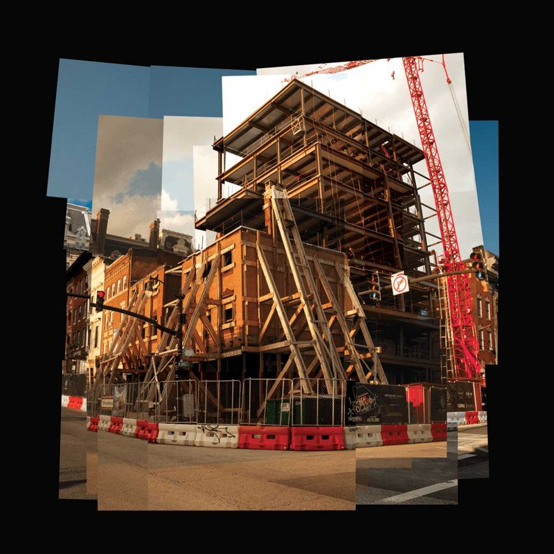 A collage of photographs shows a construction site behind metal fence and red and white plastic barriers, with crane and trusses bracing up a facade.