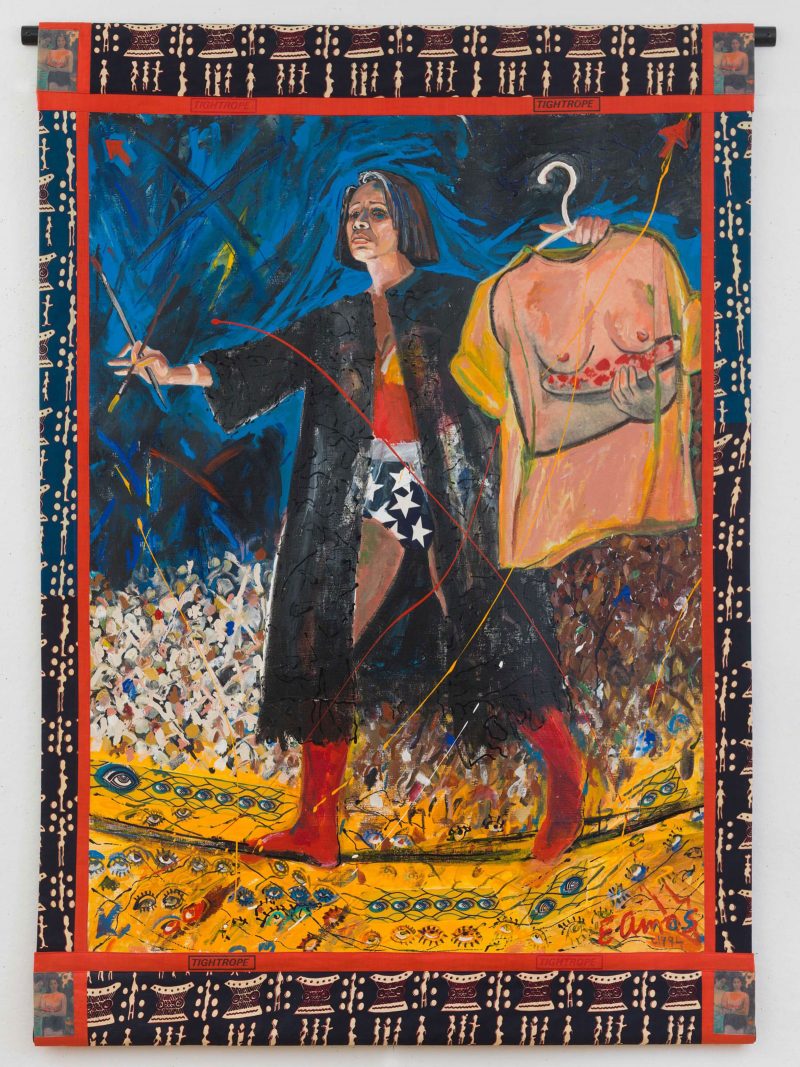 Oil painting of a women with brown skin wearing a Wonder Woman outfit with a black cloak on top, walking across a tightrope in front of a crowd; with 2 paintbrushes in a cross shape in her right hand, and a shirt with a woman's body printed on it (hanging on a hanger) in her left hand. 