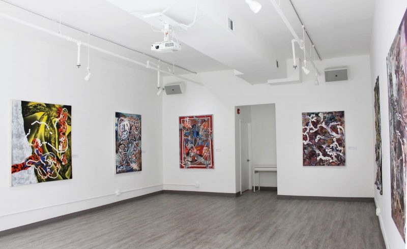 Installation view of a painting show in a gallery, with six large abstract paintings lining the walls.