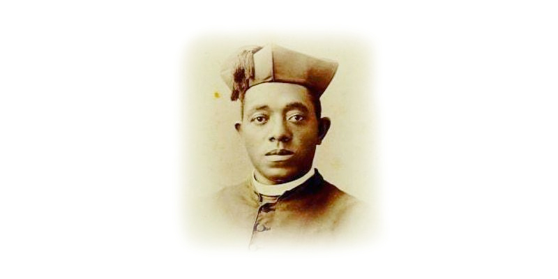 Photograph of Augustus Jackson, a Black man wearing a brown hat with a tassel, a white lapel, and a brown button up jacket.