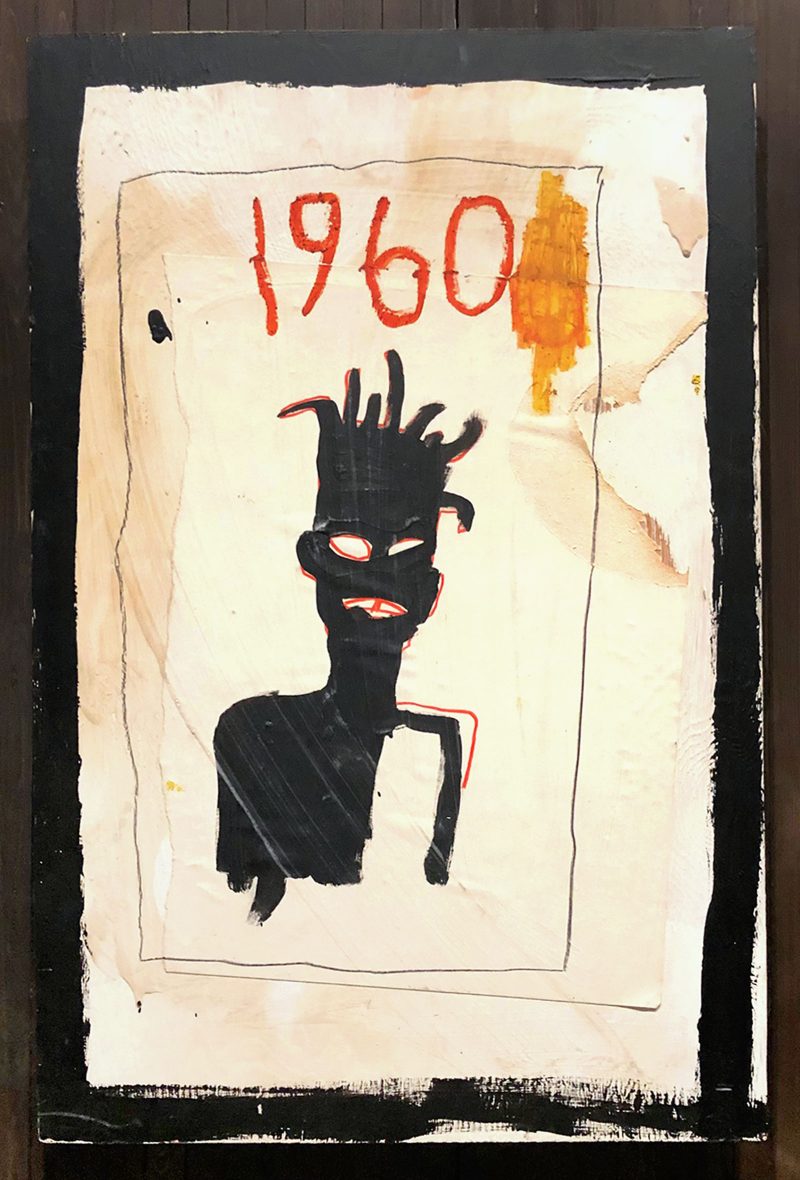 Basquiat's abstract portrait is painted in black in 2D on a white texture pattern, year "1960" It is written in red next to the yellow patch near the top. 