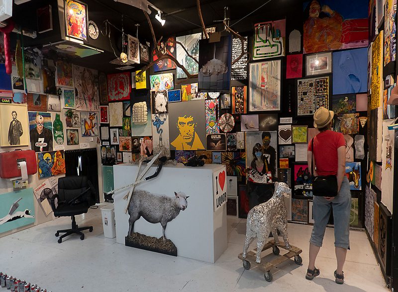 Interior view of O'Flaherty's gallery's 800 person show, with artworks tightly packed side by side on every wall and even some on the ceiling and floor.
