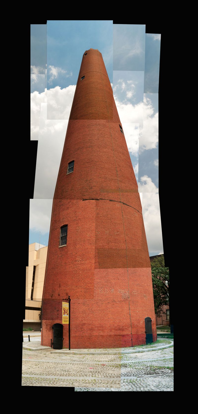 A photomontage of a red tower with forced perspective.