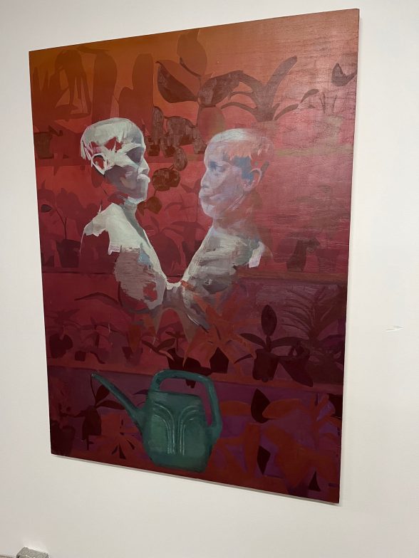 A photo of a painting on a gallery wall, depicting plants and two people facing each other.