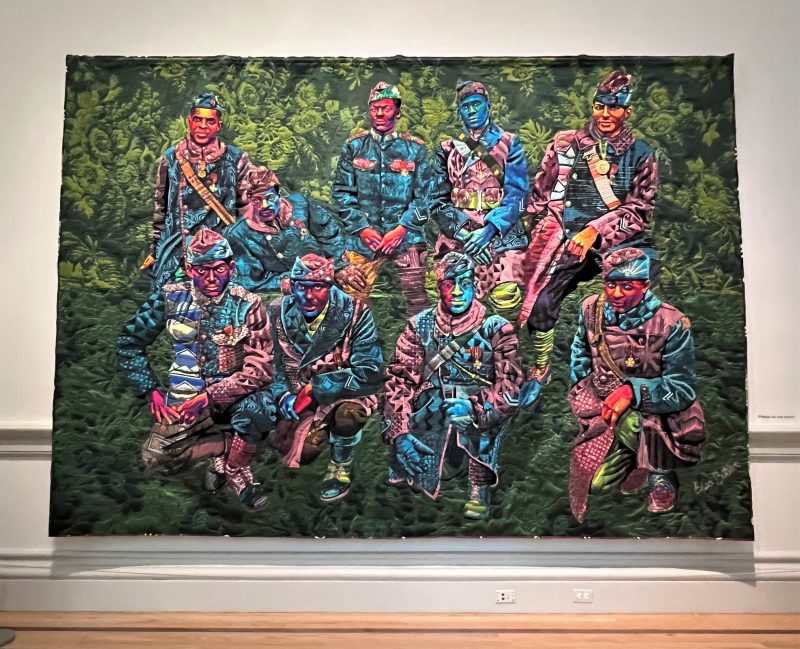 Bisa Butler's quilted artwork "Don’t Tread on Me, God Damn, Let’s Go! — The Harlem Hell Fighters" depicts the members of the 369th Infantry from World War I, who received highest honor from France but then experienced tremendous racism when they returned home to the US.