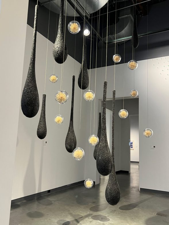 Helen Lee’s, sculpture installation "Implosive and Incendiary" is made of hanging glass, matches, and wire rope.