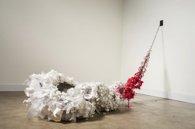 Susie Ganch’s Drag is an art installation composed of discarded plastic and metal debris.