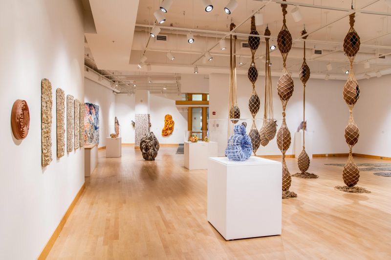 A gallery view of the show "Ex-tend Ex-cess" at Towson University’s Center for the Arts displays ceramic and mixed media sculpture in a variety of forms.
