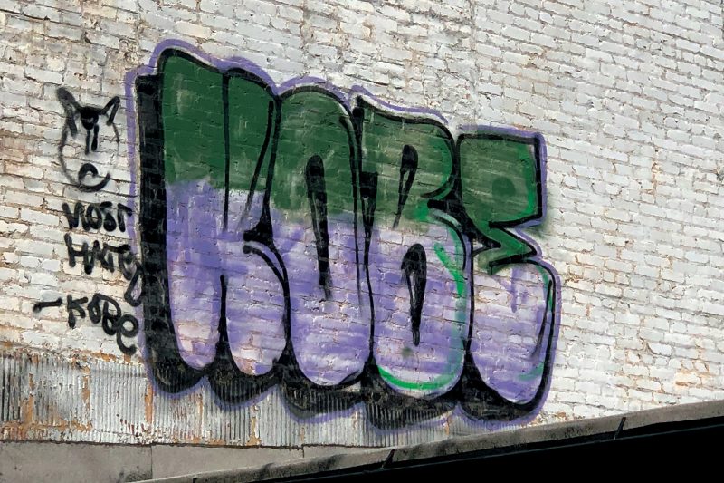 A fill-in by the tagger Kobe on a white brick wall in Baltimore.