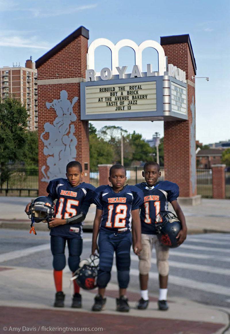 A group of young boys pose with their football gear in front of the field that replaced the Royal Theater in Baltimore, torn down in 1971.