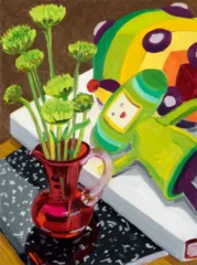 A painting by Lauren Whearty of a red pitcher with green dandelion like flowers on a canvas note book. Beside it diagonally a white book with the Namco character Katamari. it's green yellow and red with a big ball behind it of green, yellow, orange, and red with black rounded dots.
