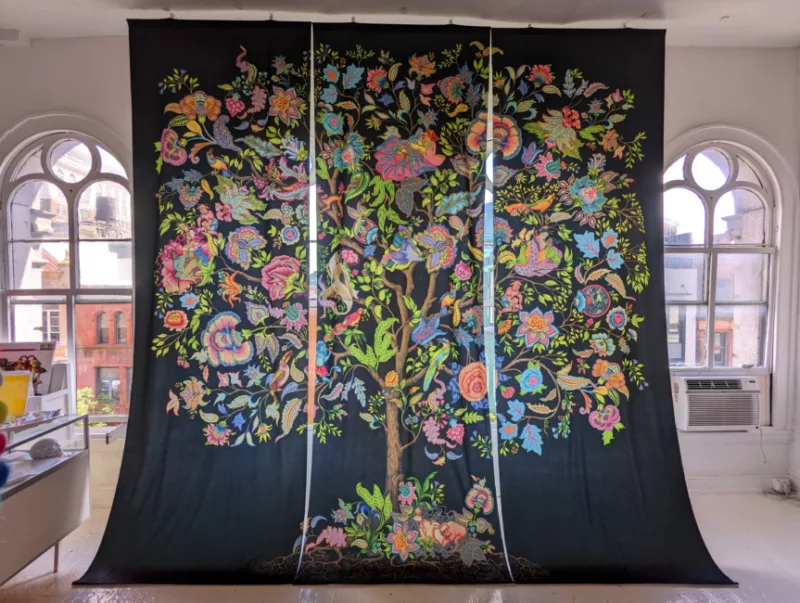 A triptych tapestry depicting the tree of life. The tree blooms with vibrant flowers and foliage as humans and creatures have intercourse throughout the tree.