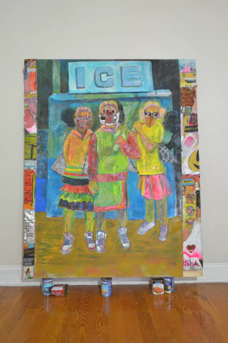 Image of a painting by Eustace Mamba titled Goya Girls (Katana) sitting in it's gallery setting atop Goya food cans. The painting depicts three girls in bright fluorescent yellows, greens, and pinks. The three girls wear face masks reminiscent of a post-apocalyptic scenario and stand in front of an Ice machine. The borders of the painting feature iconography from Papi stores and convenience stores in a jumble.
