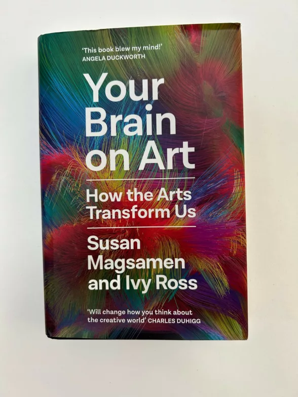 A book cover shows an abstract background of beautiful colors and on top, in white, the words, "Your Brain on Art" How the Arts Transform Us, Susan Magsamen and Ivy Ross