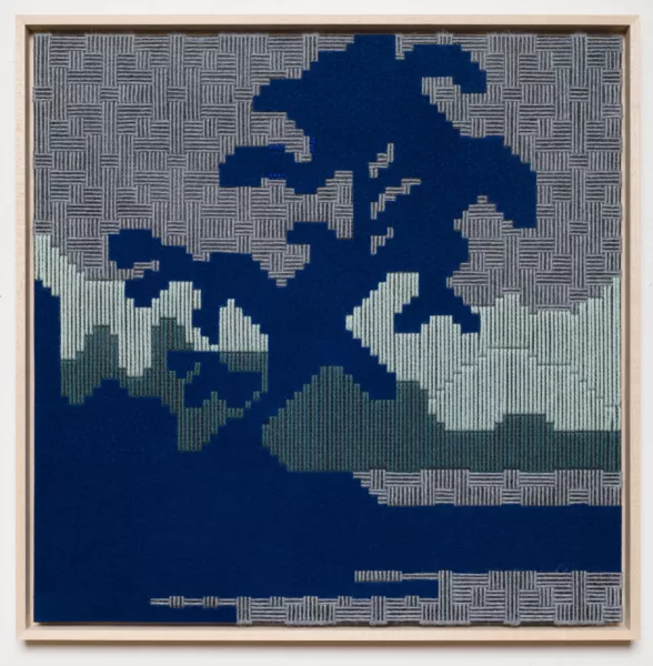 An embroidered piece of cloth shows abstract shapes that might be a dark blue river, a dark green urban skyline from a distance and possibly mountains in the distance or a wall. The abstracted landscape is beautiful but hard-edged and pixillated, which gives it a fearsome affect.