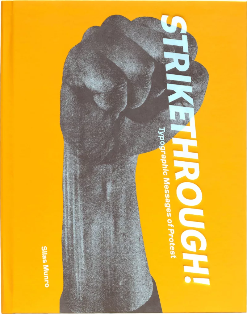 A book cover for the book "Strikethrough" shows a raised arm and fist in a Black power salute, with a bright orange background. The word "Strikethrough" runs vertically in the right of the fist partly covering it.