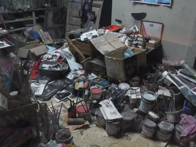 A famous 20th Century painter, Francis Bacon’s studio floor shows a space inhabited by so many cans of paint and paintbrushes, rollers and boxes filled with images and books toppling over onto the floor covered with newspaper.