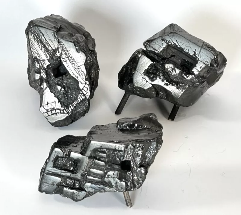 Three small pieces of carved anthracite coal “Grotesques” look like Frankenstein versions of geodes, where instead of beautiful crystals in the middle there are ugly scratching and other marks of abuse of the rock including big square holes representing a mine shaft entrance.