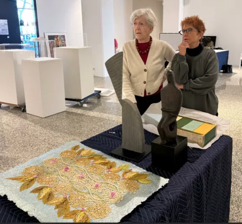 Judith Brodsky (left) and Diane Burko, installing the (re)FOCUS exhibition at Moore College of Art and Design, 2024. Photo by Jack Stawowczyk. Photo used with permission