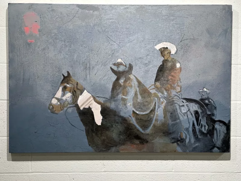 An atmospheric painting shows three cowboys on horses wearing hats, the one in front wearing a white badge of authority on his left shoulder. The three are paused in a dusty, ambiguous haze.