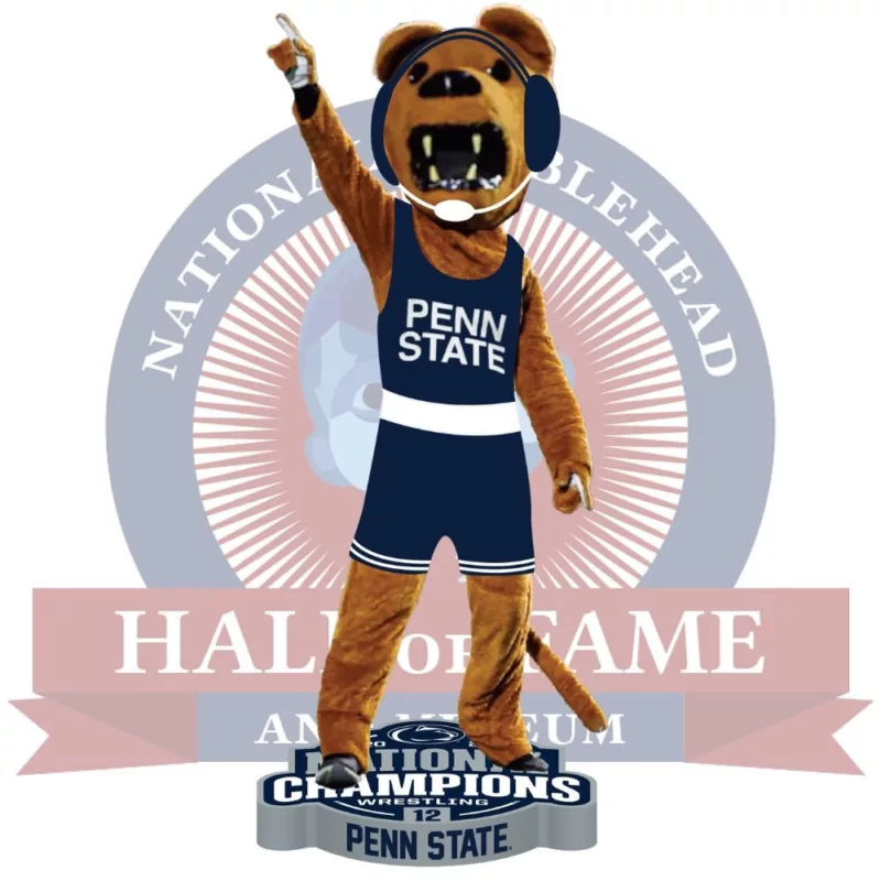 A poster in red, blue, and grey and white shows a bobblehead of the Penn State Nittany Lions mascot wesrting a wrestlig onesie and pointing his finger in the air signalling we're number one!