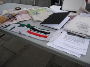 The kiosk talbe was filled with Iraqi newspapers, fliers and other reading materials