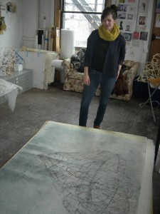 the artist, in her studio with a large print