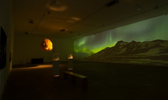 Magnus Siguardson's "Contained STORM I" in front, while “Sun” by Hrafnhildur Arnardóttir hangs from above and "Lopayesa" plays on the wall.